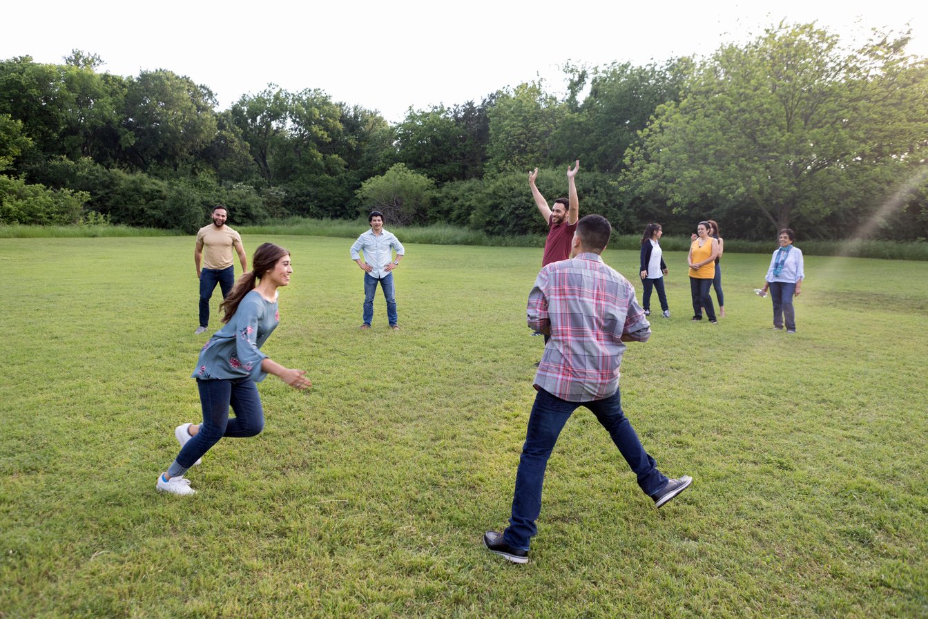 Mid adults play game while mature adult women watch