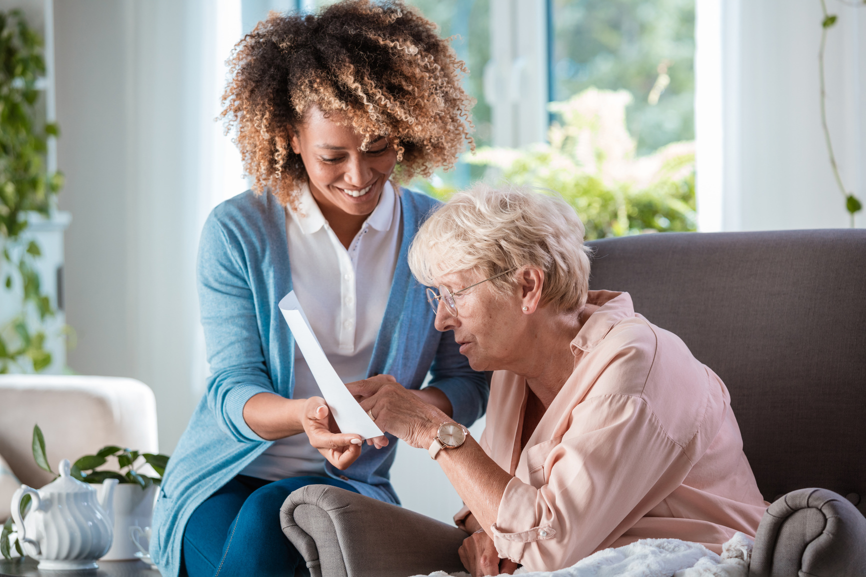 Home carer supporting senior woman